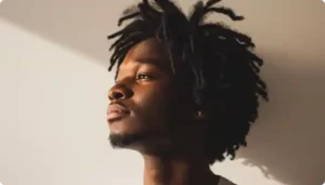 A depressed young man gazing thoughtfully at an empty space.
